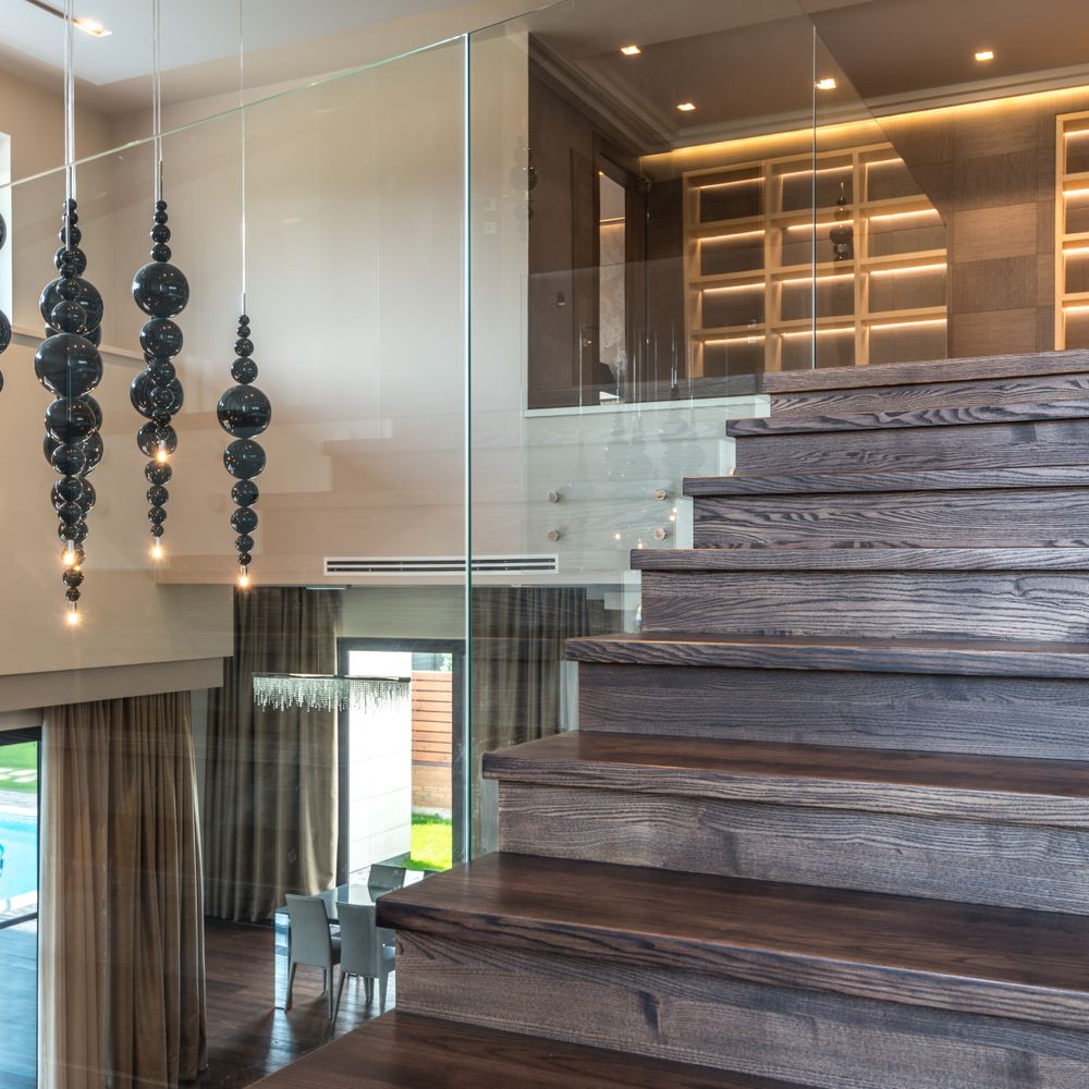 Floating wood staircase with frameless glass railing