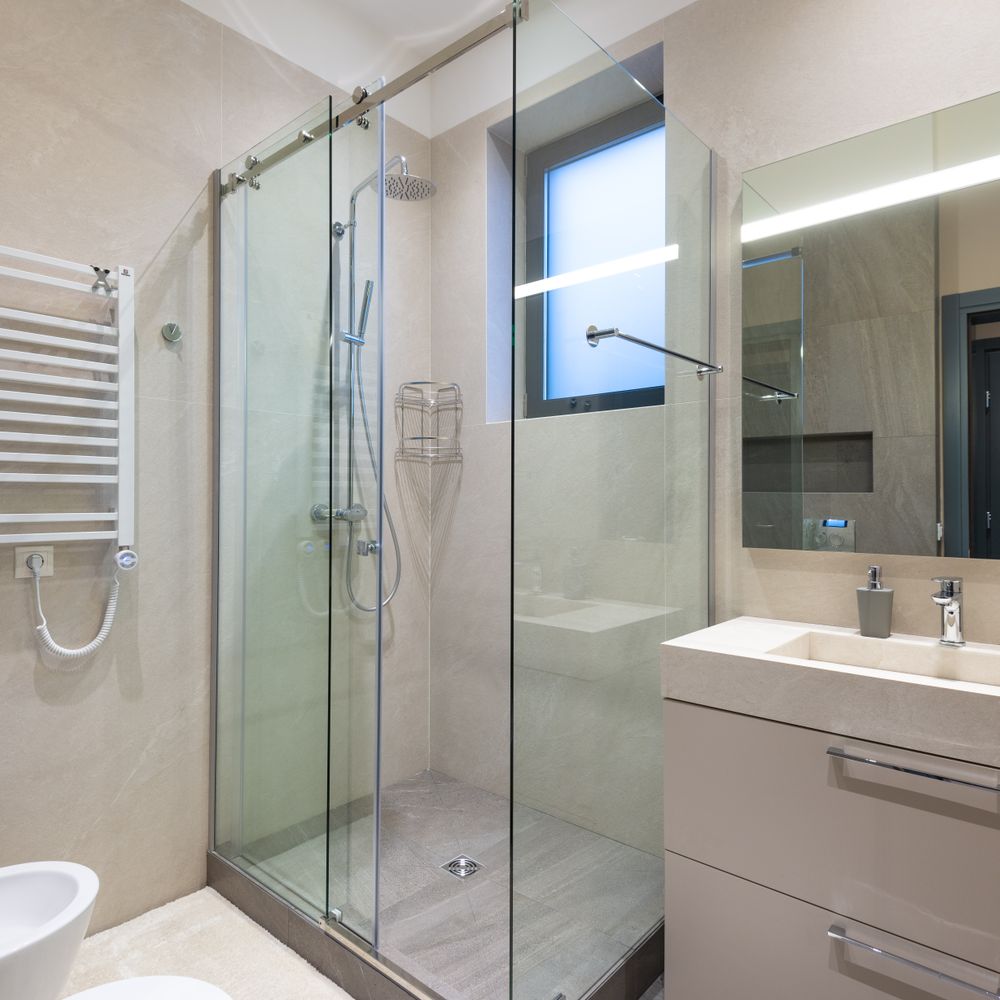 Frameless glass shower enclosure